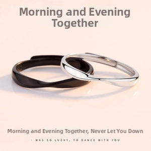 Detail view of twisted moebius couple rings in black and silver with adjustable bands