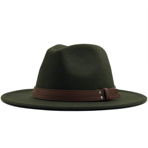 Macro view of dark green wool fedora texture and brown leather strap with metal studs