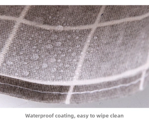 Close-up of gray grid linen fabric showing waterproof coating and water droplets