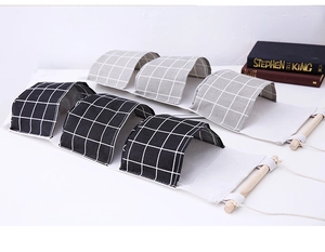 Detail view of cotton linen hanging organizers in black and grey plaid with wooden rods