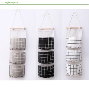 Three-tier checkered hanging organizer in grey, black, and white with cotton linen texture
