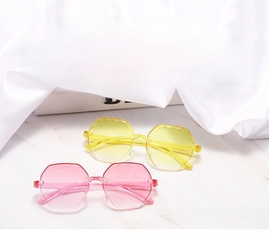 Detail of rimless polygon sunglasses featuring UV protection and jelly colored lenses