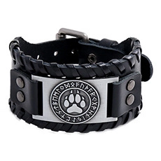 Detail view of vintage punk leather bracelet with wolf paw engraving and runes