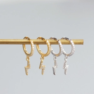 Detailed view of gold and silver S925 lightning hoop earrings with micro-set zircons