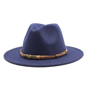 Detail view of navy fedora with brown leather band and vintage skull metal buckle