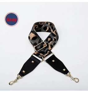 Close-up of grey leopard print adjustable shoulder strap with gold metal lobster clasps