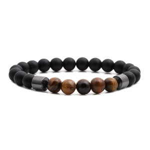 Tiger eye and matte black stone beaded bracelet with metallic spacer beads on white background
