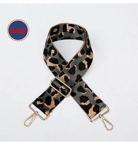 Detail of adjustable leopard print bag strap in grey with polished gold metal buckles
