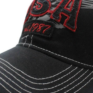 Close-up of black denim baseball cap with USA 3D embroidery and reinforced stitching