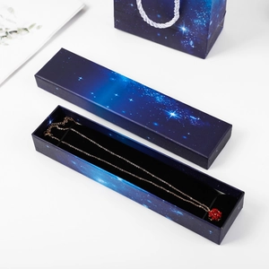 Starry sky gift box and tote bag set showcasing a gold necklace with red clover pendant