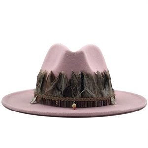 Pink wide brim fedora hat featuring bohemian feather trim and vintage coin charm