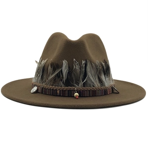 Detail of wool fedora with bohemian feather trim, ethnic woven band, and coin charms
