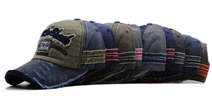 Close-up of vintage 1969 embroidery and distressed denim details on baseball caps