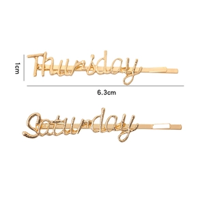 Detailed size view of gold alloy script hair clips showing Thursday and Saturday designs