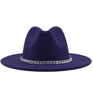 Macro shot of dark purple wool fedora hat featuring a bold silver metal chain band