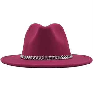 Detailed view of the rose red wool fedora hat with a bold silver metal chain band