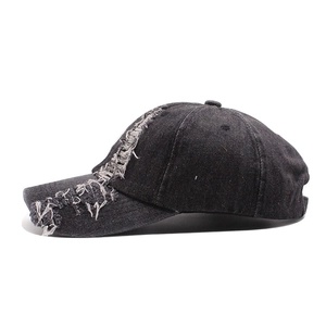 Vintage black washed denim baseball cap with distressed ripped details and street style