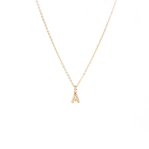 Close-up of gold A-letter pendant necklace featuring sparkling pavé cubic zirconia