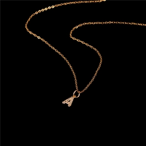 Macro shot of gold letter A pendant with sparkling crystals on a fine link chain
