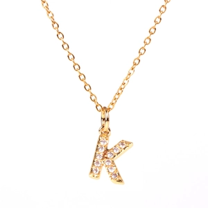 Gold letter K pendant necklace with sparkling pavé crystals on a delicate link chain