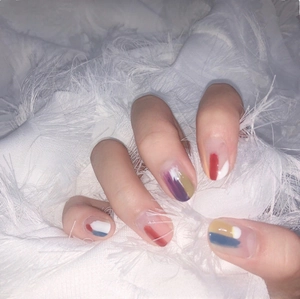 Detailed view of ultra-thin 3D nail art stickers with abstract colorful patterns on hand