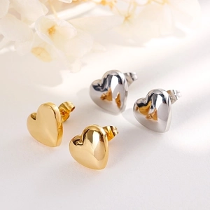 Minimalist heart stud earrings set in polished gold and silver finish stainless steel