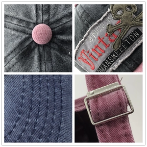 Washed cotton baseball cap with vintage skull patch embroidery and metal strap buckle