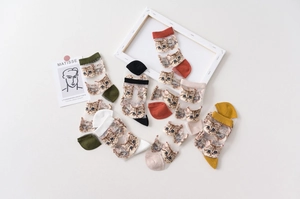 Close-up of sheer mesh crew socks with cat pattern and reinforced colorful toes