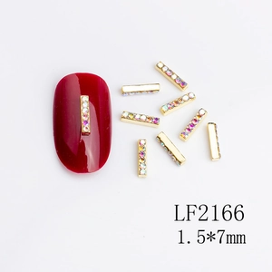 Macro view of gold metal nail art bars with AB rhinestones for manicures, size 1.5x7mm