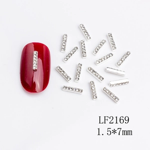 Macro shot of 1.5x7mm silver metal nail art strips with inlaid rhinestones and red nail art