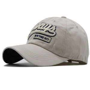 Detail of blue 'always' 3D embroidery and NYC patch on beige cotton baseball cap