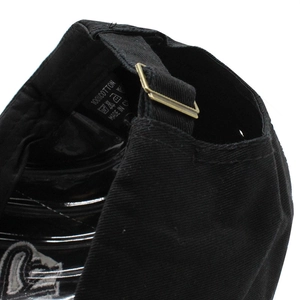 Black cotton baseball cap showing adjustable metal buckle and internal wash label details