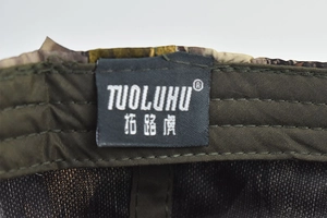 Detail view of the camouflage hunting cap showing inner sweatband and brand label