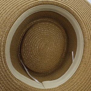 Internal detail of straw hat showing fine spiral weaving and adjustable size drawstrings