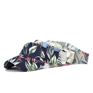 Outdoor sun visors with tropical floral patterns in navy, cream and blue colors