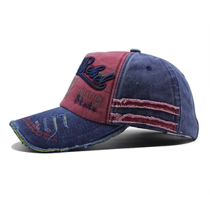 Detail of distressed red and blue washed denim baseball cap with Rebel embroidery