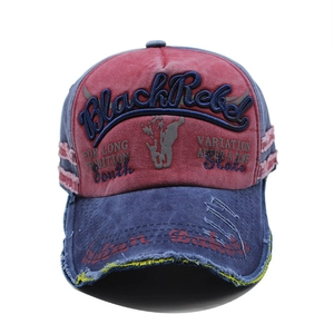 Vintage washed baseball cap in red and navy with Black Rebel embroidery and distressed finish