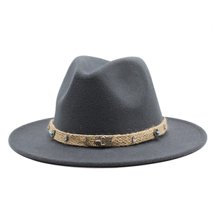 Detail of dark grey wool fedora featuring a woven band with metal scorpion and turquoise beads