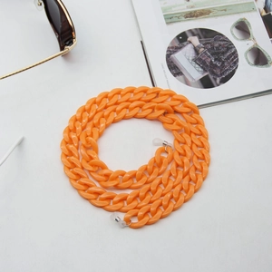 Close-up of bright orange acrylic link eyewear chain for sunglasses with silicone loops
