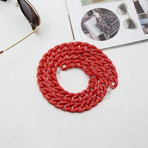Macro view of bold red acrylic eyewear chain with silicone loops for sunglasses