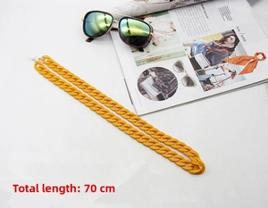 Close-up of 70cm yellow acrylic eyewear chain with glossy oval links on a white background