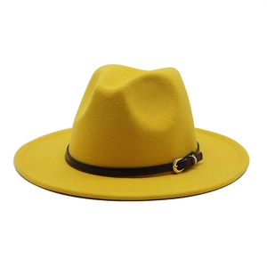 Close-up of ginger wool fedora hat with black leather strap and gold buckle detail
