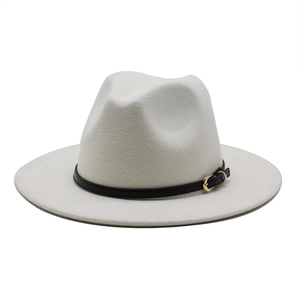Detail of white wool fedora hat with a black leather band and gold metal buckle