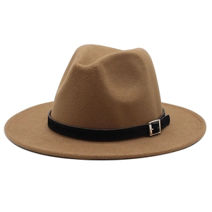 Detailed shot of camel wool fedora hat featuring a black leather belt and metal buckle