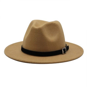 Close-up of camel felt fedora hat featuring a black leather band and silver metal buckle