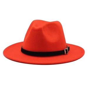 Detailed view of red felt fedora hat featuring a stylish black leather belt buckle band