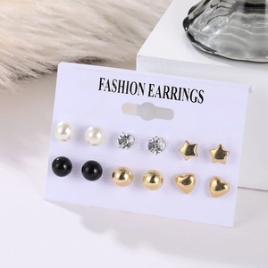 Detail of 6-pair earring set with pearls, rhinestones and stars on display card