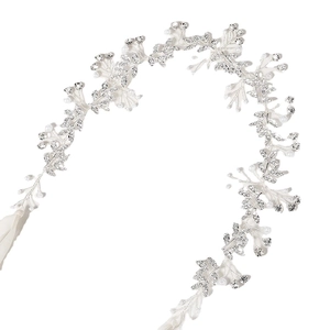 Detailed close-up of crystal leaf bridal headband with white pearls and silver wire