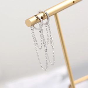Elegant S925 sterling silver tassel earrings with zircon hanging on a golden T-stand