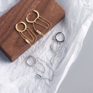 Detail view of S925 sterling silver chain tassel hoop earrings in gold and silver finish
